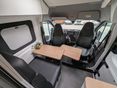 swivel chairs, fold out table, second bed area